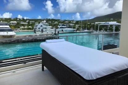 st martin massage bed at with amber linen on deck overlooking simpson bay marina 